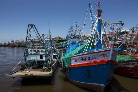 Fishing vessels are seen docked after fishing operations stopped at a port in Samut Sakhon province, Thailand, July 1, 2015. REUTERS/Athit Perawongmetha