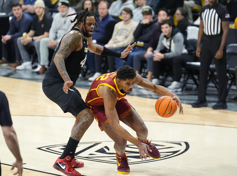Southern California forward Arrinten Page, right, drives past Colorado center Eddie Lampkin Jr., left, in the first half of an NCAA college basketball game Saturday, Jan. 13, 2024, in Boulder, Colo. (AP Photo/David Zalubowski)
