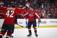 Washington Capitals defenseman John Carlson (74) celebrates after his goal with Martin Fehervary (42) during the first period of an NHL hockey game against the Boston Bruins, Monday, April 15, 2024, in Washington. (AP Photo/Nick Wass)