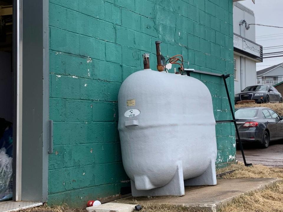 A heating oil tank behind a building is shown in this file photo. The price of the fuel has risen dramatically this year in Nova Scotia. (Laura Meader/CBC - image credit)