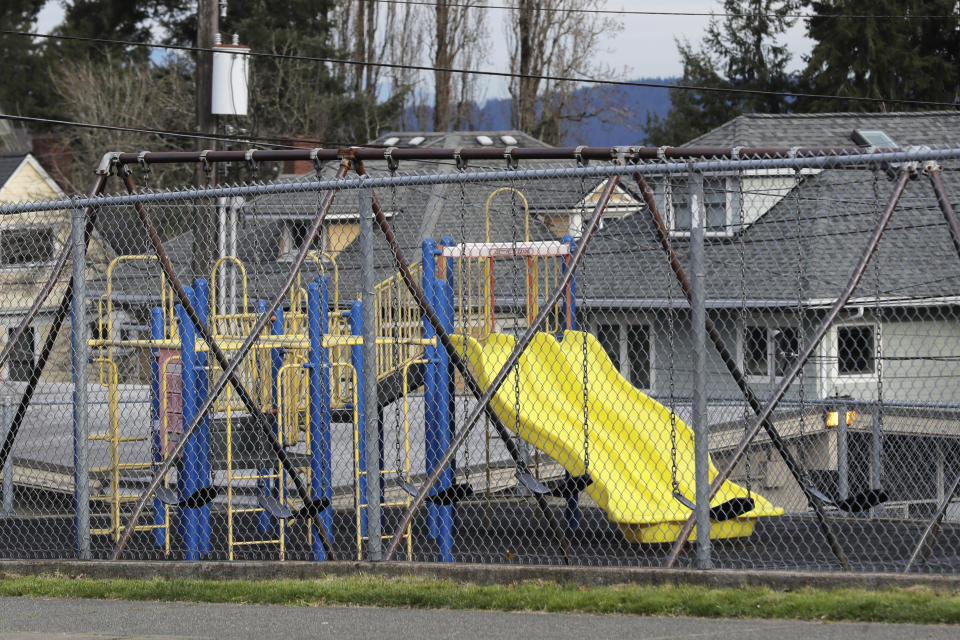 FILE - In this Tuesday, March 10, 2020 file photo, the playground at Lowell Elementary School in Tacoma, Wash., sits empty, after the school was closed Tuesday and will remain closed at least through the end of the week due to a person at the school testing presumptive positive for the new coronavirus. Many parents are now deciding how to talk to their children about the virus. Some said they are checking in daily, while others worry talking about it could make their kids more anxious or fearful. (AP Photo/Ted S. Warren, File)