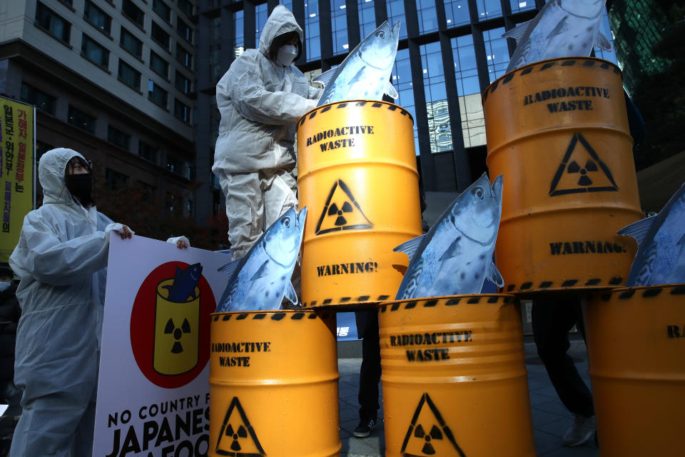 SEOUL, SOUTH KOREA - NOVEMBER 09: South Korean environmentalists with mock nuclear waste drum containers stage a rally against Japan's disposal of radioactive water plan at the Fukushima nuclear power, in front of Japanese embassy on November 09, 2020 in Seoul, South Korea. Activists to call on the Japanese government to retract its plan to release water containing radioactive materials stored at the Fukushima nuclear power plant in Japan. (Photo by Chung Sung-Jun/Getty Images)