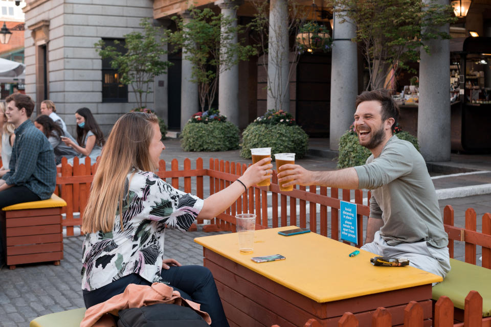  A couple cheering with their beers at an outdoor area set up for drinking at the Covent Garden, London.
As the UK government lifted the restrictions imposed on dining services in relation to COVID, crowd of people flooded restaurants, bars and pubs across central London over the weekend to grab a drink. Restaurants are doing their best to ensure a hygiene within their premises, and are still adopting measures to maintain a safe dining distance between tables. People are seen to be very excited about the re-opening in London. (Photo by Belinda Jiao / SOPA Images/Sipa USA) 