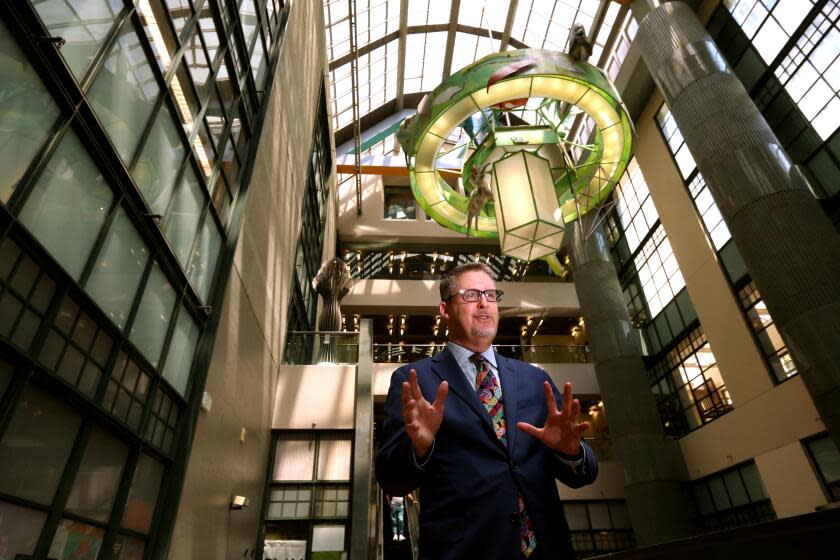 LOS ANGELES, CA - JULY 10, 2023 - City Librarian John Szabo stands in the main lobby of the Central Library in downtown Los Angeles on July 10, 2023. Szabo oversees the Los Angeles Central Library and its 72 branches spread out over 503 square miles. The library's mission has expanded much since it was founded in 1872 with 500 books for a "bustling pueblo" of 6,000 people. Today, it has more than eight million books and serves the largest and most diverse population of any library in the country. It rides the cusp of technological change: ebooks, artificial intelligence, trained computer "cybernauts" and 7,000 loanable Tech2go bundles complete laptop and hotspot connections. Szabo was photographed on July 10, 2023. (Genaro Molina/Los Angeles Times)