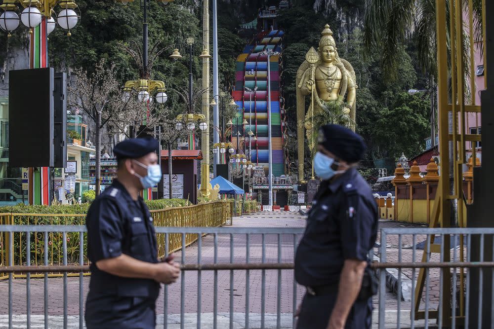 Police personnel stand guard in front of Batu Caves during Thaipusam January 28, 2021. — Picture by Hari Anggara