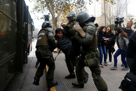 A demonstrator is detained during an unauthorized march called by secondary students to protest against government education reforms in Santiago, Chile, May 26, 2016. REUTERS/Ivan Alvarado