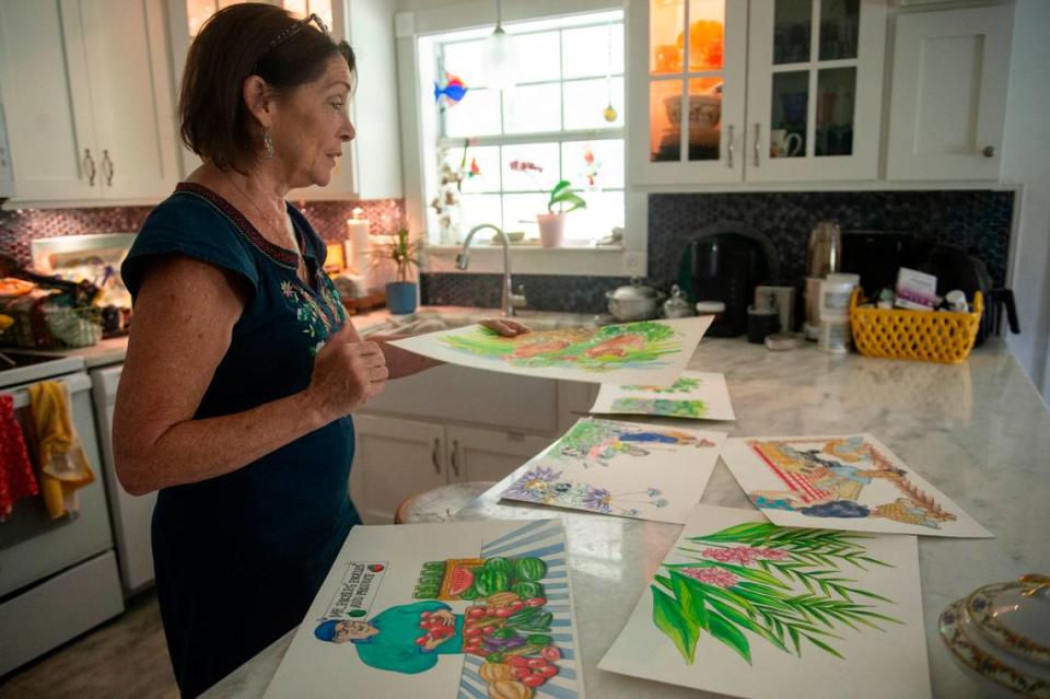 Tami Curtis Guy, who is an artist, displays illustrations for a children’s book that her husband Perry Guy wrote. The Guys have been fighting to receive money they were granted through FEMA to elevate their home to protect from flooding.