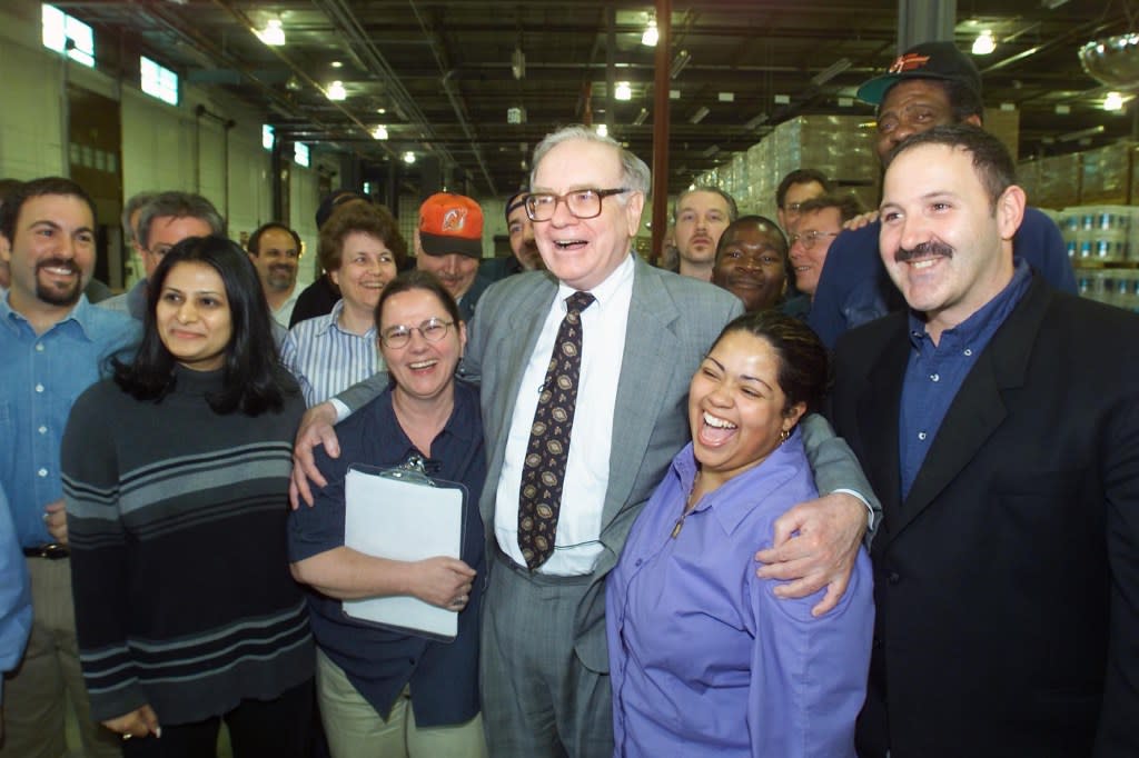 Warren Buffett with his new family from Benjamin Moore Paints at the Clifton, N.J. distribution center during his first visit to Benjamin Moore on Tues May 8, 2001. Buffett's Berkshire Hathaway officially became Benjamin Moore's owner on January 1,2001. Contact Jocelyn Kalsmith 212-885-0443. (photo by Gabe Palacio/Getty Images)