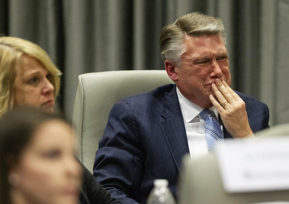 Mark Harris, Republican candidate in North Carolina's 9th Congressional race, fights back tears at the conclusion of his son John Harris's testimony during the third day of a public evidentiary hearing on the 9th Congressional District voting irregularities investigation Wednesday, Feb. 20, 2019, at the North Carolina State Bar in Raleigh. (Travis Long/The News & Observer via AP, Pool)