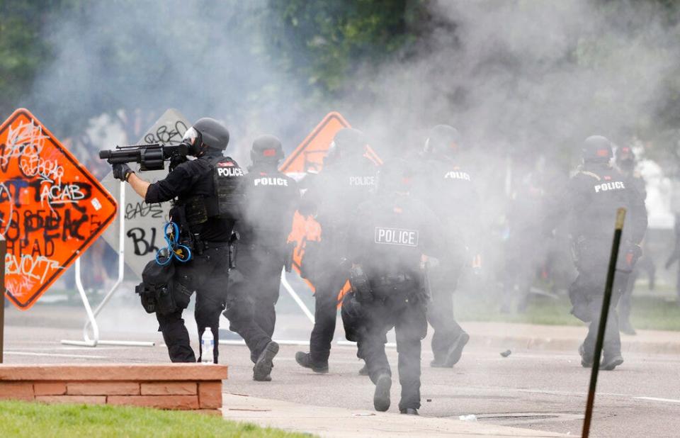 Denver police fire tear gas canisters during a protest May 30, 2020, outside the state Capitol over the death of George Floyd.