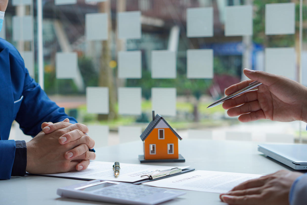 Real estate ideas, selling a house, or renting out real estate. The sales representative discusses the terms of the home sales contract for the customer to sign the legal contract document,