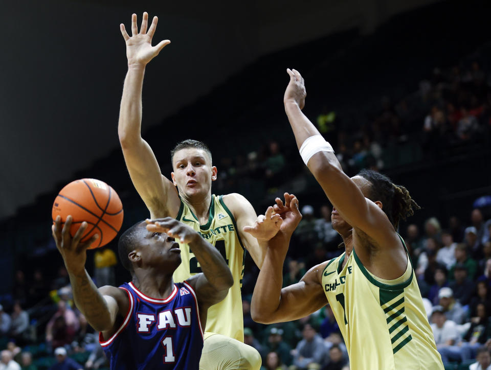 Florida Atlantic guard Johnell Davis (1) shoots against Charlotte forward Igor Milicic Jr., and center Dishon Jackson, right, during the first half of an NCAA college basketball game in Charlotte, N.C., Saturday, Jan. 6, 2024. (AP Photo/Nell Redmond)