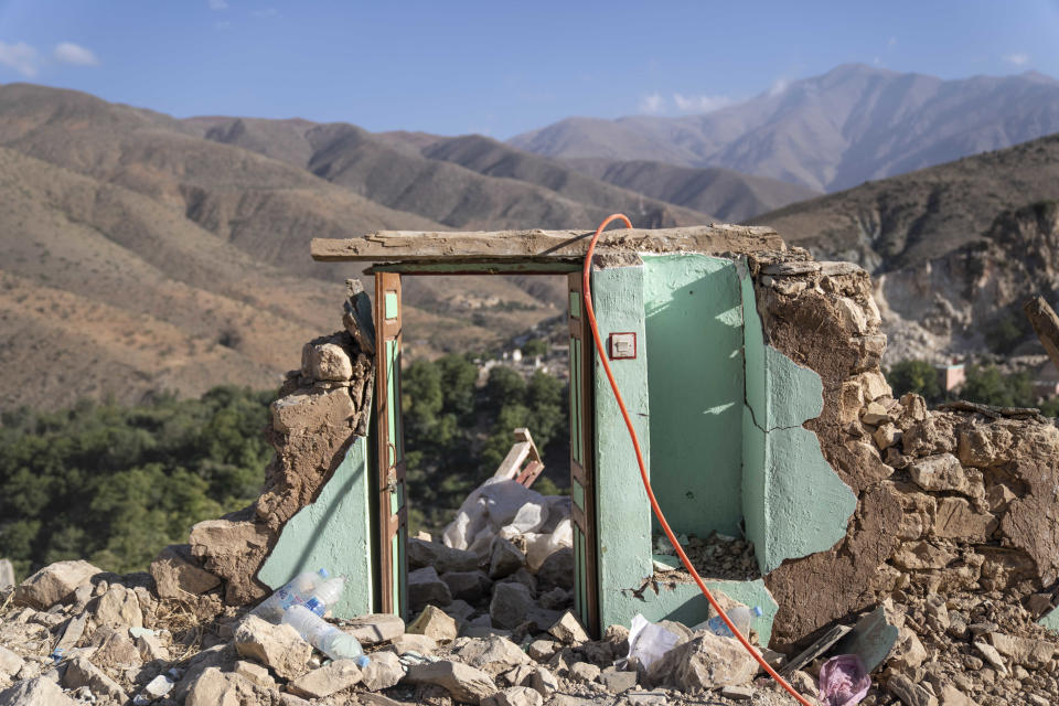 The door of what used to be a home stands amidst rubble which was caused by the earthquake, in the town of Imi N'tala, outside Marrakech, Morocco, Wednesday, Sept. 13, 2023. An aftershock rattled central Morocco on Wednesday, striking fear into rescue crews at work in High Atlas villages, digging people out from rubble that could slide. (AP Photo/Mosa'ab Elshamy)