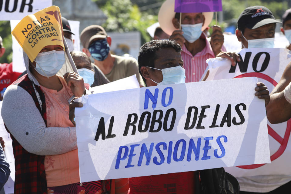 A man holds a sign with a message that reads in Spanish; "Don't steal our pensions," during a protest against the country adopting Bitcoin as legal tender, along the Pan-American Highway, in San Vicente, El Salvador, Tuesday, Sept. 7, 2021. El Salvador became the first country to adopt Bitcoin as legal tender Tuesday, but the rollout stumbled in its first hours and President Nayib Bukele informed that the digital wallet used for transactions was not functioning. (AP Photo/Salvador Melendez)