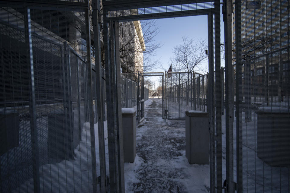 The entrance to the U.S. Federal Courthouse is surrounded by gates, Monday, Jan. 24, 2022, in St. Paul, Minn. Monday was the first day of testimony in the federal trial of three former Minneapolis cops implicated in George Floyd's death. (Renee Jones Schneider/Star Tribune via AP)