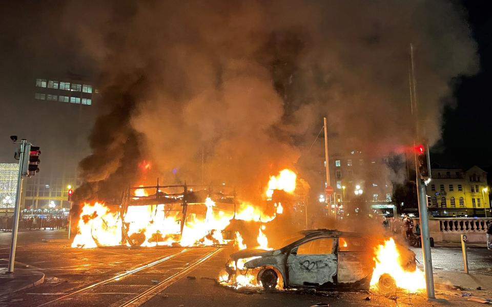 A bus and car on fire on O'Connell Street in Dublin city centre during the riot