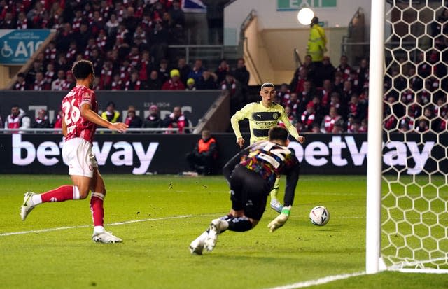 Phil Foden, right, scores Manchester City’s first goal