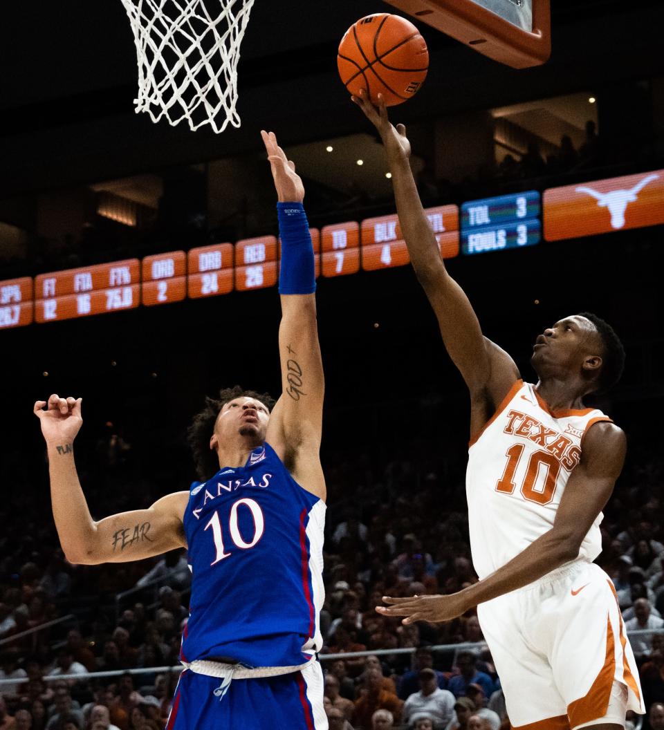 Texas guard Jabari Rice, right, lays in a basket against Kansas' Jalen Wilson during the Longhorns' win Saturday at Moody Center. The sixth man of the year in the Big 12, Rice ranks second on the team in scoring per game (12.6) and fourth in assists (63) and minutes per game (24.2) and is tied for fourth in rebounding per game (3.5).