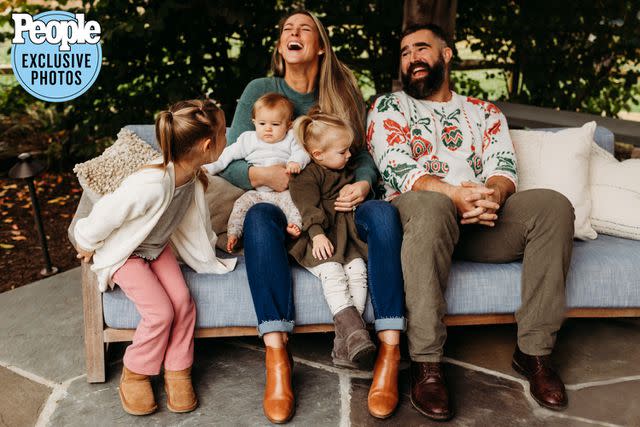 <p>Stephanie Beatty for Minted</p> Jason and Kylie kelce laugh with daughters Wyatt, Bennett, and Elliotte