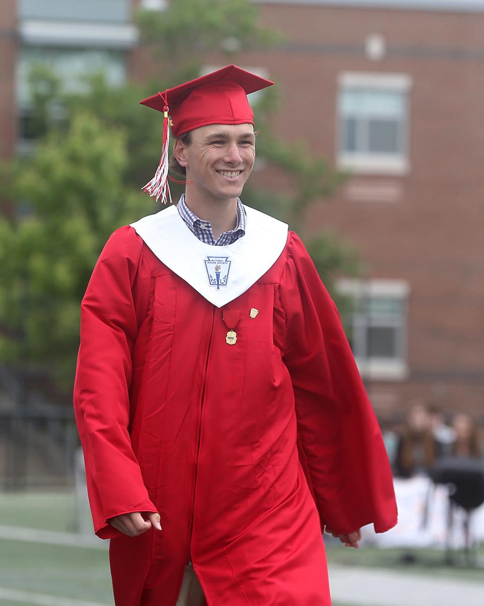 Thomas Barnet smiles while walking across the field to receive his diploma during Hingham High’s graduation ceremony for the Class of 2023 on Saturday, June 3, 2023. Hingham High graduated 318 seniors. 