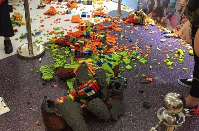 The aftermath of the smashed sculpture with scattered bricks across the exhibition floor. Picture: Weibo