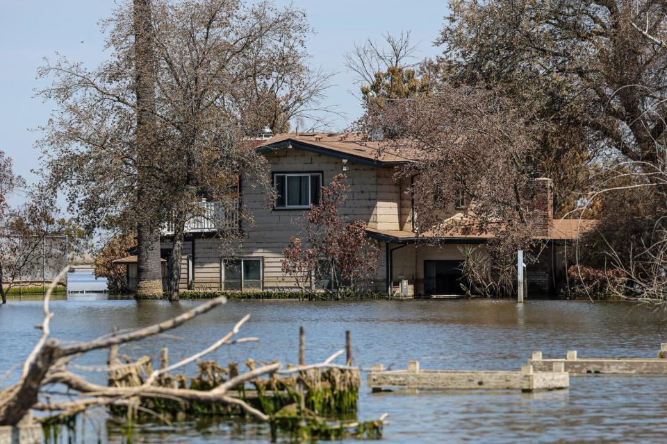 A home on the Hansen family's land is surrounded by floodwaters.