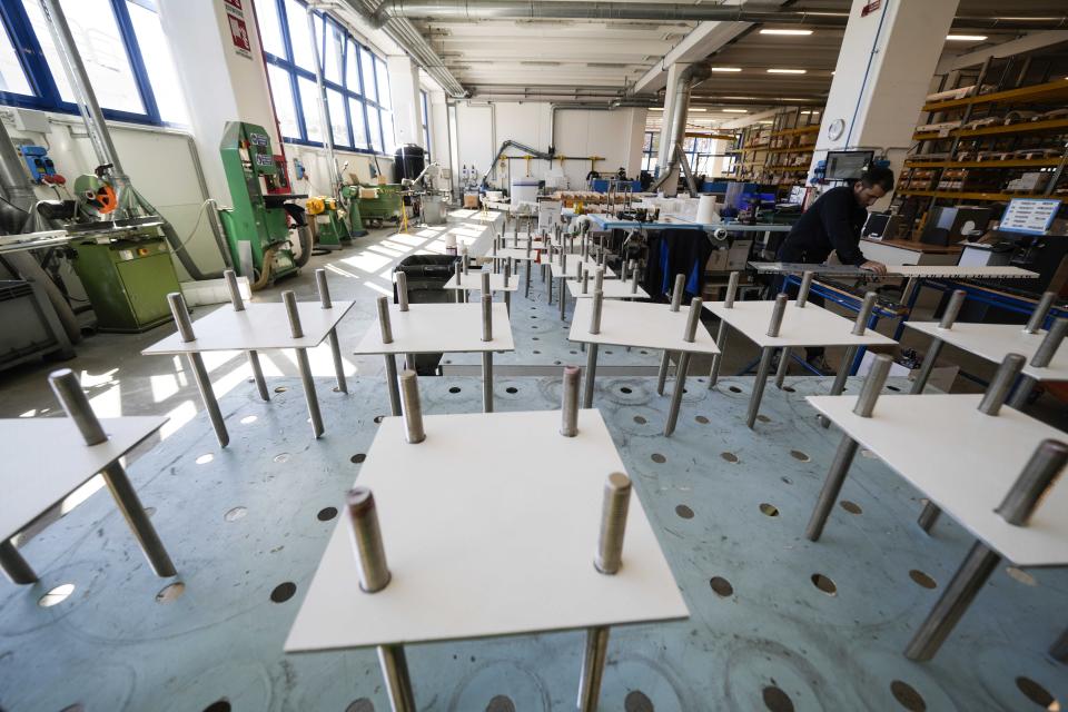 A worker checks measurements of a pool section at the Myrtha Pools factory, in Castiglione delle Stiviere, northern Italy, Tuesday, March 12, 2024. Italian company Myrtha Pools is producing 24 pools for the Paris Olympics at its factory in Castiglione delle Stiviere, near Verona. The pools will be used for swimming, diving, water polo, artistic swimming and training areas in Paris. It's the sixth Olympics that Myrtha will be providing pools for. (AP Photo/Luca Bruno)