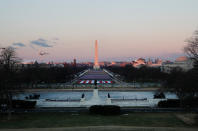 <p>The Washington Monument and <a href="https://people.com/politics/what-to-know-about-the-flags-at-joe-bidens-inauguration/" rel="nofollow noopener" target="_blank" data-ylk="slk:"Field of Flags";elm:context_link;itc:0;sec:content-canvas" class="link ">"Field of Flags"</a> at sunrise ahead of the 59th presidential inauguration Wednesday. </p>