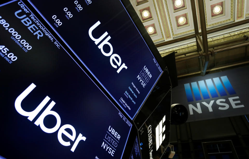 Screens display the Uber Technologies Inc. logo above the floor of the New York Stock Exchange (NYSE) during the company's IPO in New York, U.S., May 10, 2019. REUTERS/Andrew Kelly