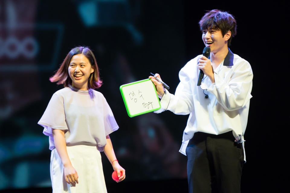 INFINITE’s Kim Myung-soo on stage with a fan at his first fan meeting in Singapore (Photo: PTO Entertainment Pte Ltd)
