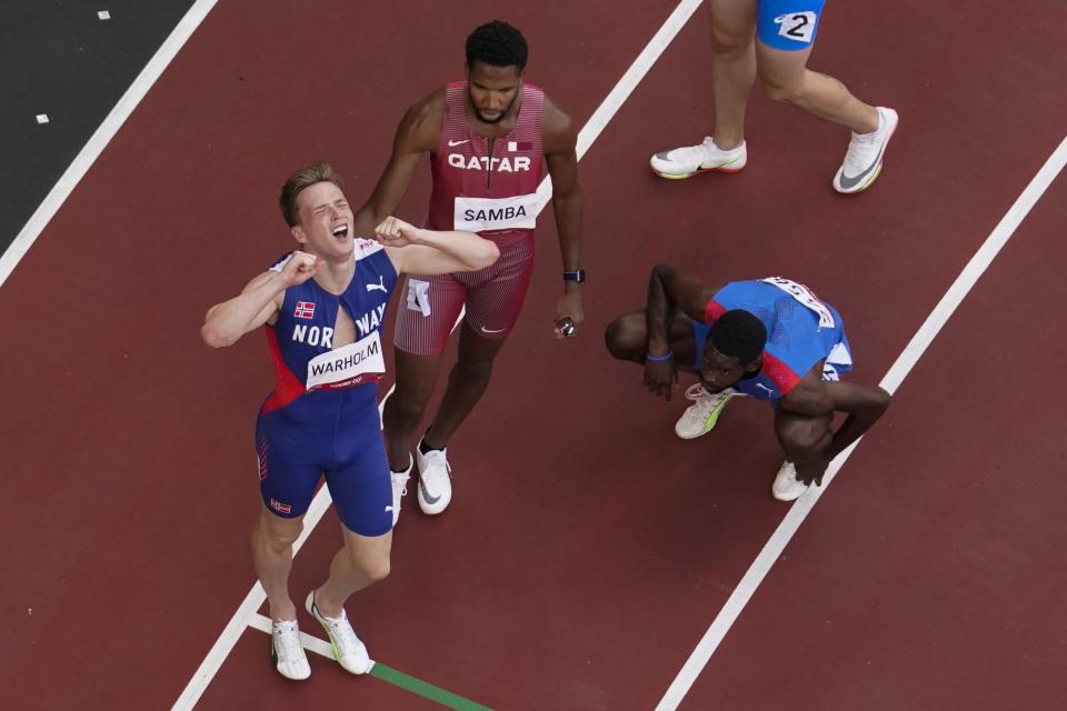 Karsten Warholm, of Norway, celebrates after winning a gold medal during the finals of the men's 400-meter hurdles at the 2020 Summer Olympics, Tuesday, Aug. 3, 2021, in Tokyo. (AP Photo/Morry Gash)