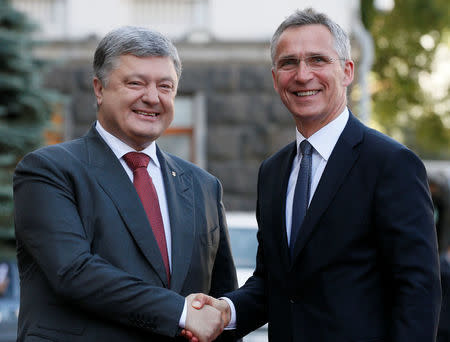 Ukrainian President Petro Poroshenko shakes hands with NATO Secretary General Jens Stoltenberg before a meeting in Kiev, Ukraine, July 10, 2017. REUTERS/Valentyn Ogirenko