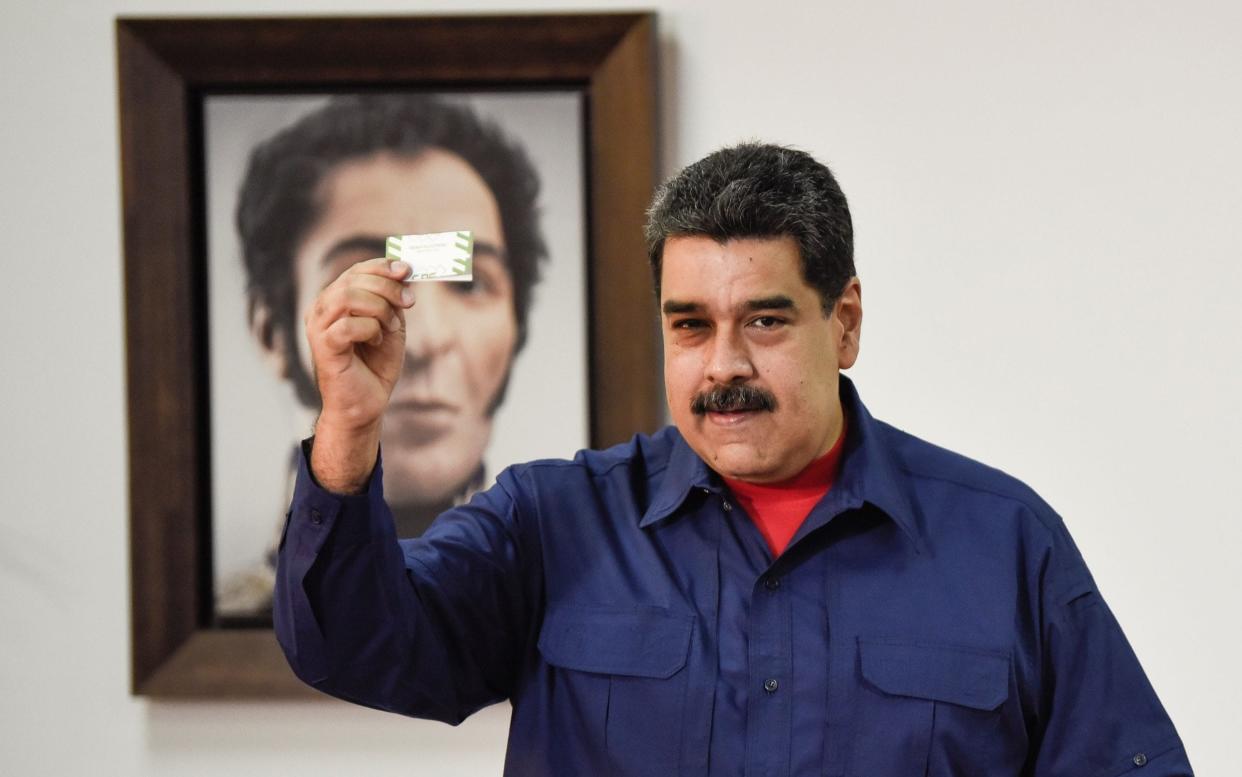 Nicolas Maduro holds his vote receipt after casting his vote at a polling station during municipal election in Caracas, Venezuela - Anadolu