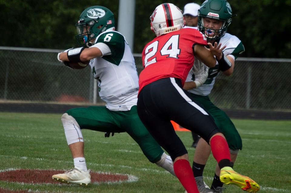 Rams running back Casey Loper (6) looks for open field as Litchfield's Logan Buehrle (24) looks to make the tackle.