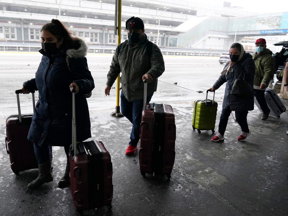 Travelers arrive at Terminal 3 at O'Hare International Airport in Chicago, Thursday, Dec. 22, 2022.