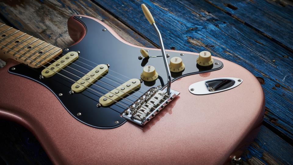 A Fender Stratocaster lying on a wooden floor