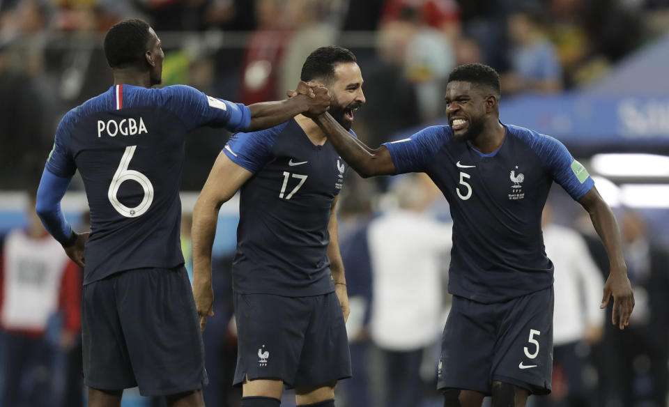 France’s Samuel Umtiti, right celebrates with Adil Rami, centre and Paul Pogba after defeating Belgium.