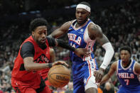 Toronto Raptors guard Kobi Simmons (8) tries to get the ball around Philadelphia 76ers forward Paul Reed (44) during the first half of an NBA basketball game Sunday, March 31, 2024, in Toronto. (Frank Gunn/The Canadian Press via AP)