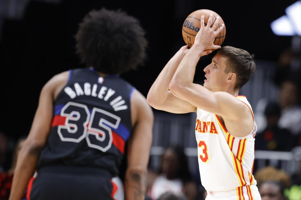 Atlanta Hawks guard Bogdan Bogdanovic, right, shoots as Detroit Pistons forward Marvin Bagley III watches during the second half of an NBA basketball game Tuesday, March 21, 2023, in Atlanta. (AP Photo/Alex Slitz)