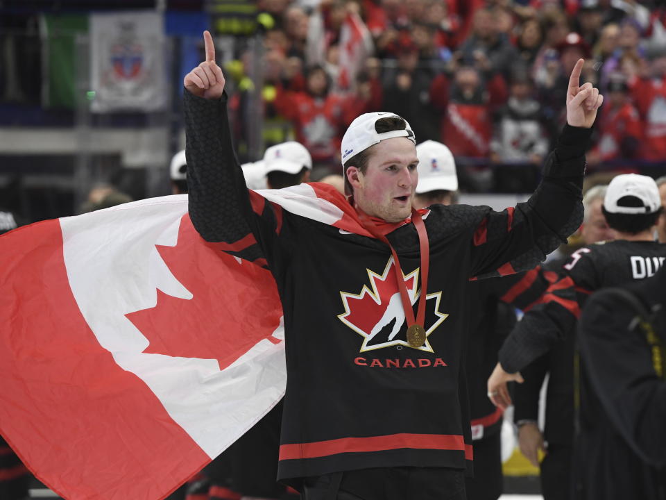 Canada's Alexis Lafreniere wears a Canadian flag as he celebrates after defeating Russia in the gold medal game at the World Junior Hockey Championships, Sunday, Jan. 5, 2020, in Ostrava, Czech Republic. (Ryan Remiorz/The Canadian Press via AP)