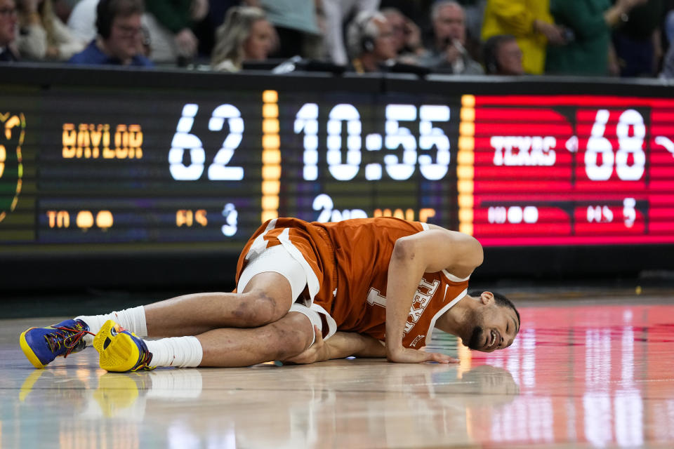 Texas's Dylan Disu reacts after suffering an injury during the second half of an NCAA college basketball game against Baylor, Monday, March 4, 2024, in Waco, Texas. Baylor won 93-85. Disu did not return to the court. (AP Photo/Julio Cortez)