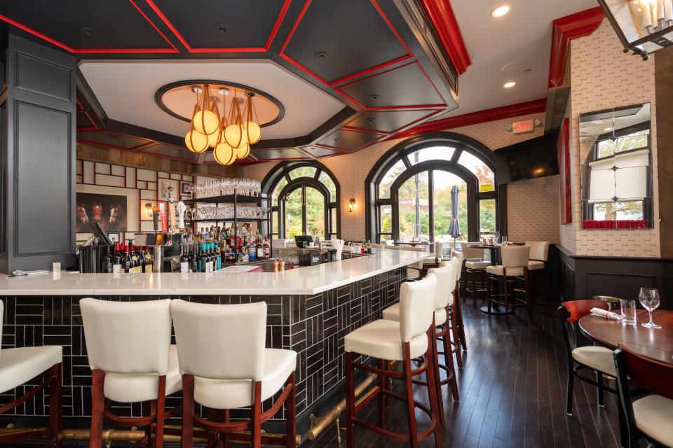 A new, white 22-seat marble-topped bar with white bar stools and banquettes at the Red Horse.