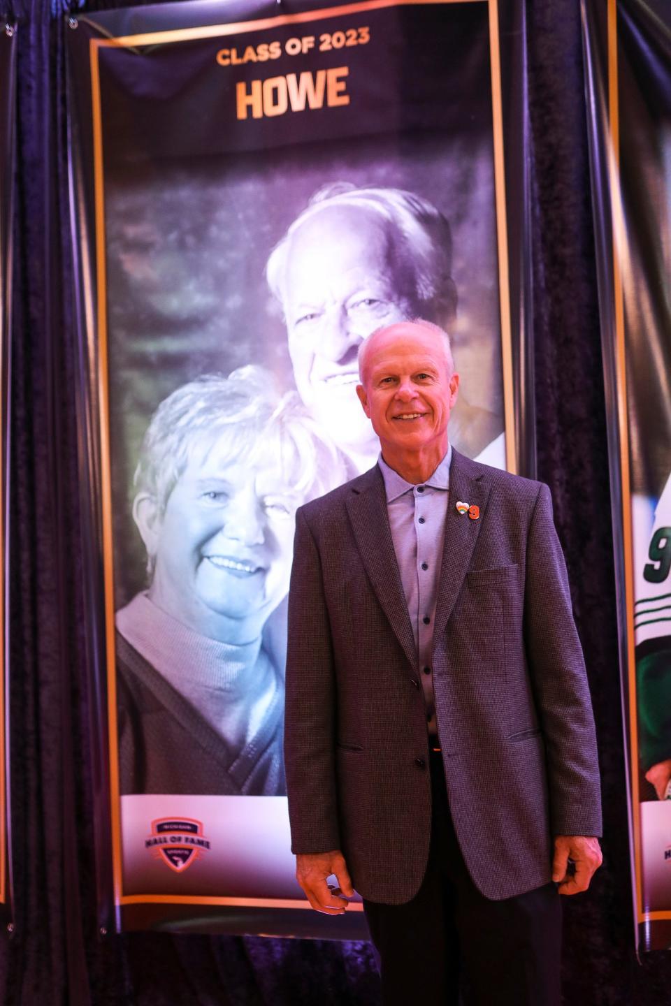 Mark Howe, son of Gordie and Colleen Howe, pose for a photo in front of a post of his parents during Michigan Sports Hall of Fame Class of 2023 induction ceremony at Soundboard Theater in Detroit on Thursday, Sept. 14, 2023.
