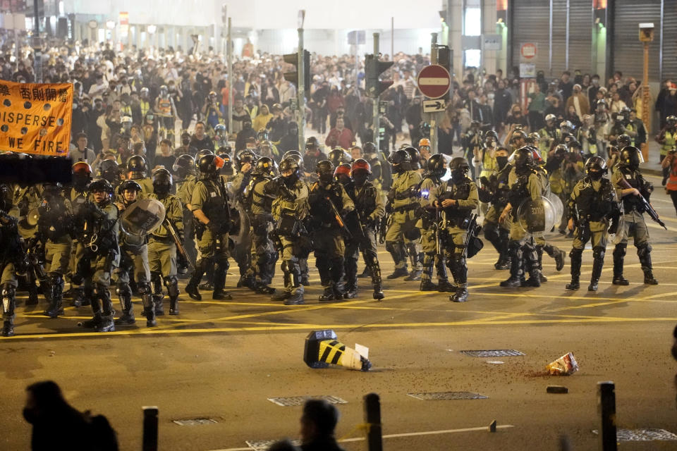 Riot police gather as they confront protesters during a rally on Christmas Eve in Hong Kong on Tuesday, Dec. 24, 2019. More than six months of protests have beset the city with frequent confrontations between protesters and police. (AP Photo/Kin Cheung)