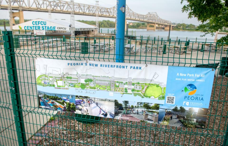 An sign on a fence outside the CEFCU Landing stage area illustrates proposed plans for major upgrades to the Peoria riverfront.