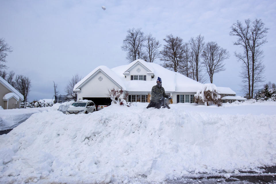 Kavi Vyas throws a snow ball at their friend across the street during a break in the snow storm hitting the Buffalo area, in Orchard Park, New York, U.S. November 19, 2022 REUTERS/Carlos Osorio