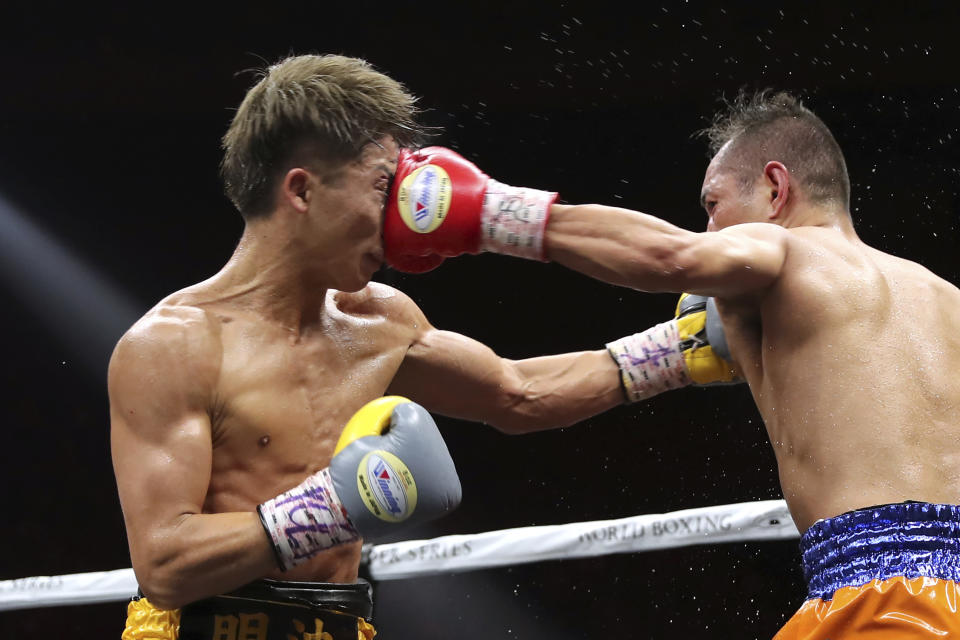 Japan's Naoya Inoue, left, gets a punch from Philippines' Nonito Donaire in the sixth round of their World Boxing Super Series bantamweight final match in Saitama, Japan, Thursday, Nov. 7, 2019. Inoue beat Donaire with a unanimous decision to win the championship. (AP Photo/Toru Takahashi)