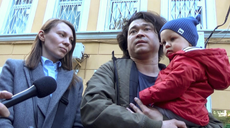 This video grab provided by TV Rain on Tuesday, Aug. 6, 2019, shows Dmitri and Olga Prokazov, parents of a 1-year-old boy speaking to journalists in Moscow, Russia . Moscow's children's rights ombudsman and other public figures have reacted with outrage to Russian prosecutors' moves to remove a 1-year-old boy from his parents because they allegedly took him to an unauthorized protest. (TV RAIN via AP)