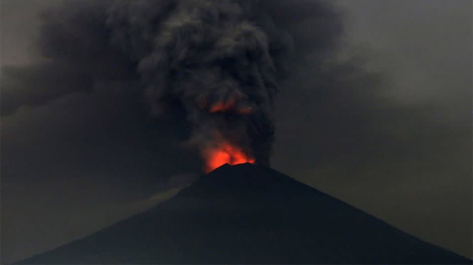 Mount Agung spitting volcanic ash more than 4000 metres into the sky, grounding flights in and out of Bali. Source: AP