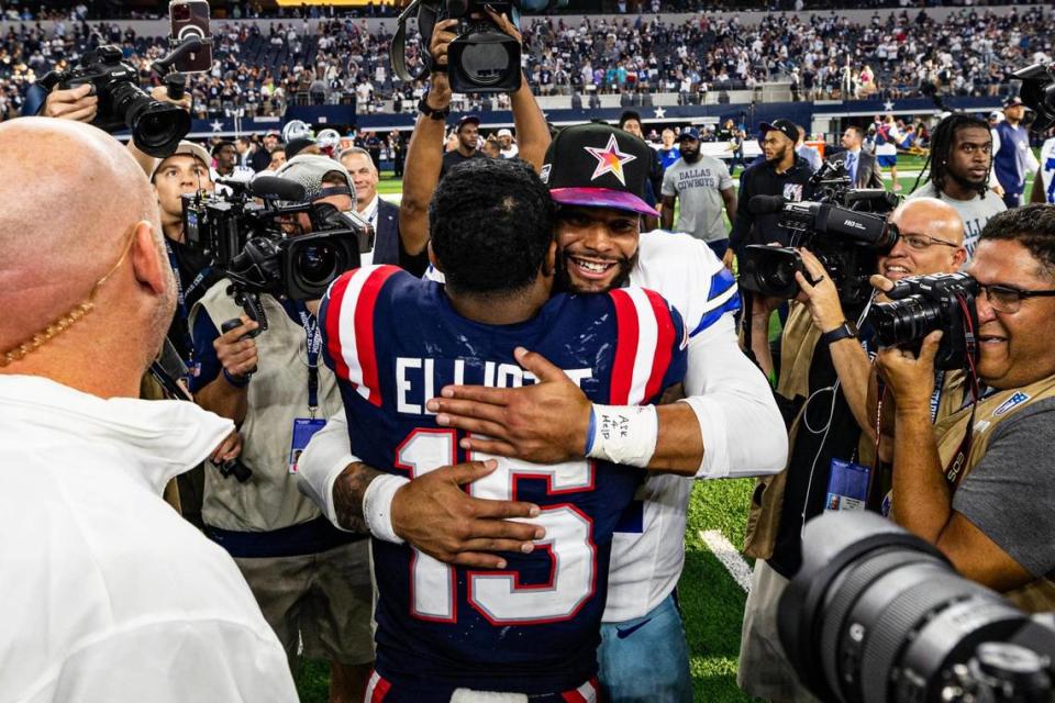 Former teammates Ezekiel Elliot (15) and Dak Prescott (4) embrace after an NFL game between the Dallas Cowboys and New England Patriots at AT&T Stadium in Arlington on Sunday, Oct. 1, 2023. The Cowboys won 38-3 in their reunion. Chris Torres/ctorres@star-telegram.com